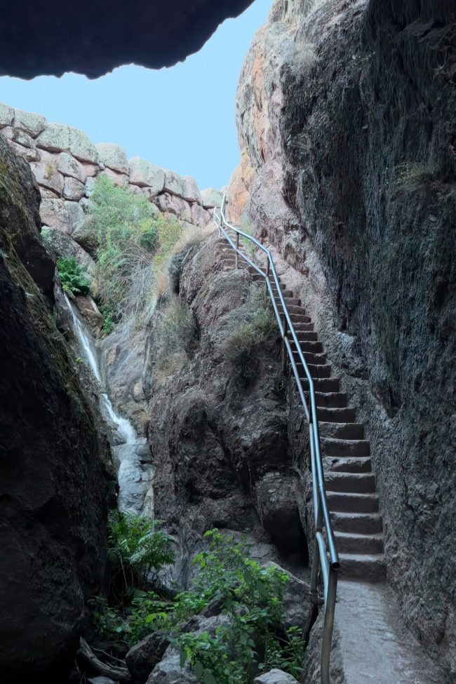 The railing staircase carved into a rockfront leading out of the Bear Gulch Cave in Pinnacles.