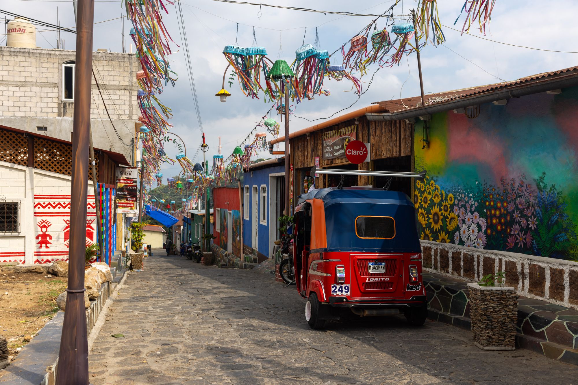 San Juan La Laguna 4 A colorful street with hanging decorations in San Juan la Laguna in Guatemala.